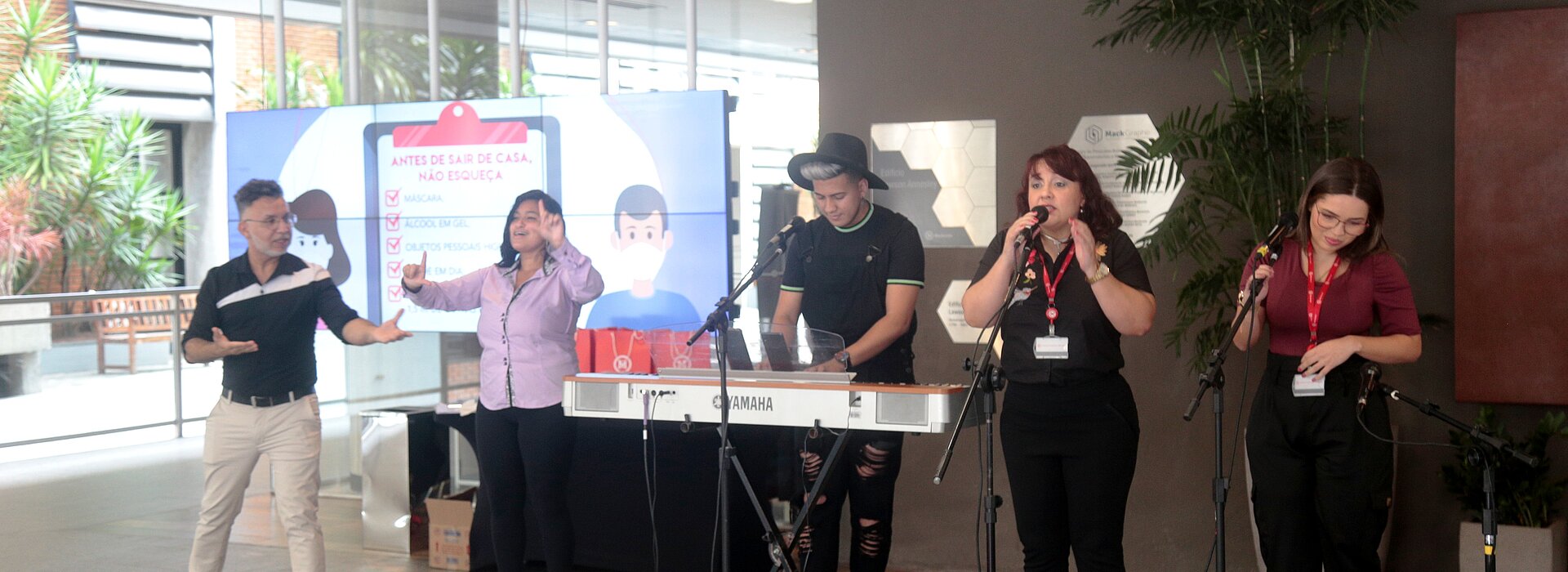 na imagem, cinco pessoas com instrumentos musicais se apresentam